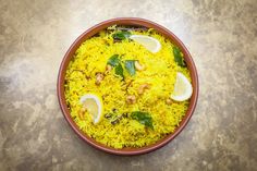 a bowl filled with rice and lemon slices