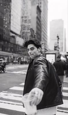 black and white photograph of a man crossing the street