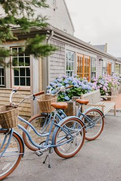 three bicycles parked next to each other in front of a building with flowers on it