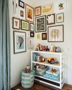 a white shelf with pictures on the wall