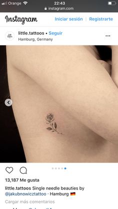 a small rose tattoo on the back of a woman's left arm and shoulder