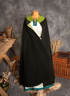 An oversized cloak is one of the most universal pieces of the medieval costume. A Cloak is made on a half-circle pattern, with a round neckline. The coat is wide enough that it can be easily wrapped around the body. The coat keeps you warm and is perfect for chilly evenings. It is a sign of high social status.  A length of a cloak is around 135 cm, the clasp doesn't come with cloak. The offer includes just wool cloak. ----------------------------------------------------------- FABRIC The materia Medieval Style Cape For Cosplay Events, Medieval Cape For Cosplay Events, Elven Cape For Cosplay And Medieval Festivals, Elven Style Cape For Cosplay, Medieval Cape For Cosplay, Elven Style Cape For Medieval Festivals, Elven Cape For Medieval Festivals, Elven Style Cape For Medieval Festivals And Costume Events, Elven Cape For Medieval Festivals And Costume Events