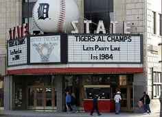 people are walking in front of the state theatre