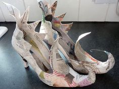 a pair of shoes made out of newspaper