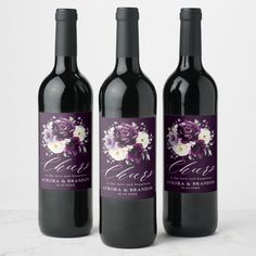 three bottles of wine with labels on them