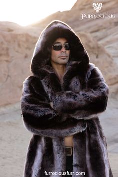 Elegant and stylish, this men's truffle brown hooded playa coat is the perfect addition to any festival fashion ensemble. Made with exclusive French Tissavel faux fur, this coat is not only silky soft but also thick and luxurious, ensuring both warmth and sophistication. Ideal for male fashion enthusiasts looking to make a statement at any event.  SHOP NOW! @ furrociousfurr.com. | Men's Fashion | Festival Style | Luxury Coat | French Faux Fur Luxury Faux Fur Coat For Cold Weather, Long Sleeve Faux Fur Mink Coat, Luxury Faux Fur Outerwear In Mink Color, Mink-colored Faux Fur Coat, Luxury Hooded Faux Fur Outerwear, Mink Faux Fur Coat With Faux Fur Lining, Mink Colored Faux Fur Coat, Luxury Fluffy Faux Fur Outerwear, Fluffy Mink Hooded Fur Coat