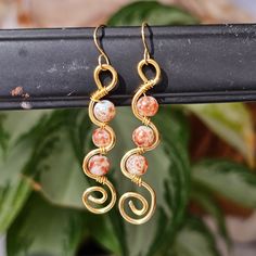 2" copper wire. wavy circle swirl earrings. meant for ear lobes. Dangle set. Perfect for gifts, personal use or events. Bohemian & hippie style. Classic design. Woman owned & crafted Bohemian Gold Wrap Earrings With Copper Wire, Artsy Wire Wrapped Earrings Gift, Adjustable Wire Wrapped Rose Gold Earrings, Adjustable Rose Gold Wire Wrapped Earrings, Handmade Bohemian Swirl Earrings, Adjustable Swirl Wire Wrapped Earrings, Adjustable Wire Wrapped Swirl Earrings, Bohemian Copper Wire Wrap Earrings, Bohemian Wrap Earrings With Copper Ear Wire