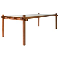 a wooden table with a glass top on it's legs and one leg missing