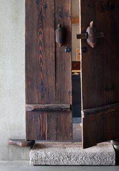 an open wooden door on the side of a building