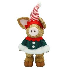 a stuffed animal pig wearing a green and red sweater with a santa hat on it's head