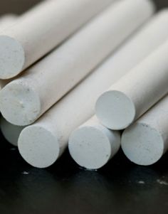 several white round rods sitting on top of a table