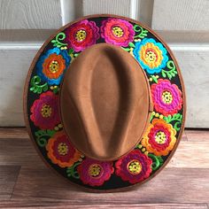 Stand out with this beautiful handcrafted Mexican Suede Hat with beautiful detailed floral embroidered canvas brim. Perfect accessory to add that with that daily outfit. MADE IN MEXICO By: Mexican Artisans For: Women Size: Medium 23' Color: brown | black | multi Details: Top Suede Embroidered canvas brim Inner elastic band Contact us for more details PLEASE READ BEFORE PURCHASE: The picture is an ACCURATE REPRESENTATION.Colors in the pictures may vary a little by effects of light. Each product i Hippie Brimmed Hat For Spring, Festival Embroidered Fedora Hat, Embroidered Fedora Hat For Festivals, Embroidered Brimmed Spring Hats, Bohemian Embroidered Fedora Hat, Spring Embroidered Fedora Hat, Bohemian Hats With Multicolor Embroidery For Festivals, Bohemian Festival Hat With Multicolor Embroidery, Bohemian Hat With Multicolor Embroidery For Festivals