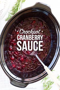 cranberry sauce in a slow cooker with a spoon