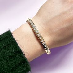 A classic way to add elegance to your arm party. This bangle can be worn for special occasions or everyday, adding a delicate shine to your look! 14K Yellow Gold19 Baguette White Diamonds at Approximately 1.55 Carats Total Weight This 5 millimeter bangle is oval and fits up to a 7.25 inch wrist Push Clasp and Extra Security Lock// Security Lock, Arm Party, Diamond Charm, Diamond Bangle, Baguette Diamond, Pink Pearl, Diamond Bracelets, Gemstone Bracelets, Gold Charm