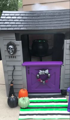 a purple and green halloween house with decorations