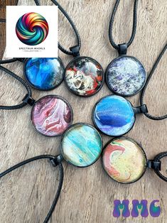 This holiday season, share the enchanting beauty of the Spectrum Whorls Collection, featuring a handcrafted fluid art necklace with a sleek black round bezel. Each piece is a one-of-a-kind creation, formed from a vibrant symphony of acrylic paints poured into mesmerizing patterns. Sealed under a 25mm round glass cabochon, this unique artwork is beautifully framed by the black alloy bezel. Paired with an elegant 16" black cord, this necklace offers a sophisticated yet bold statement, making it the perfect holiday gift for someone special. * A perfect holiday gift: This stunning fluid art necklace is a thoughtful and unique present, perfect for Anniversary, Birthday, Christmas, Hanukkah, Kwanzaa, or any holiday occasion, ideal for art lovers and those who appreciate handcrafted beauty. * Han Black Pendant Necklace, Present Perfect, Black Circle, Art Necklaces, Christmas Hanukkah, Art Pendant, Black Pendant, Holiday Jewelry, Unique Presents