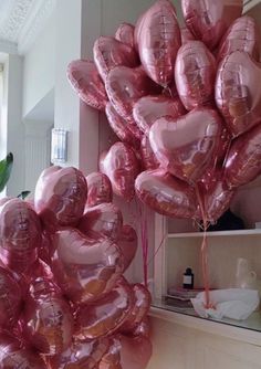 pink heart shaped balloons hanging from the ceiling