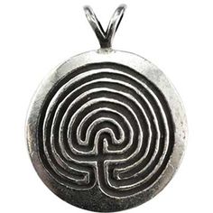 a silver pendant with a maze design on it