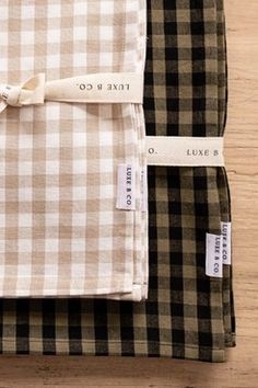 three different plaid cloths are folded on top of each other