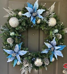 a christmas wreath with blue and silver decorations