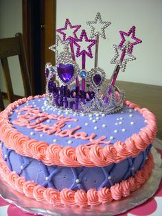 a birthday cake with pink frosting and purple icing, decorated like a tiara