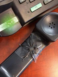 a broken cell phone sitting on top of a wooden desk