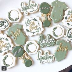 some cookies are decorated with green and gold icing on top of each cookie is the words baby, it's a boy