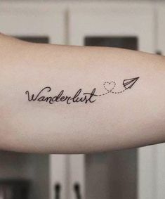 a woman's arm with the word wanderlust written on it