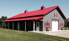 a red roof on a gray barn