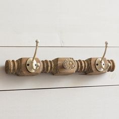 three wooden knobs are attached to the wall