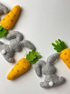 felt bunny and carrots are hanging on the wall