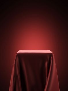 a red table cloth on top of a wooden chair with a black back dropper