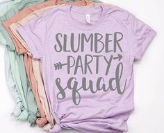 a pile of shirts sitting next to each other on top of a white surface with the words summer party squad printed on them