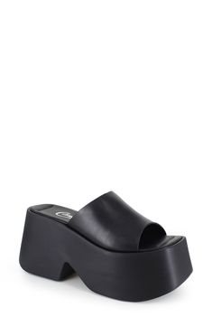 A sky-high platform and block heel elevate a retro-inspired slide sandal rendered in smooth leather for timeless appeal. 4" heel; 2 1/2" platform; 1 1/2" slope Leather upper and lining/synthetic sole Made in Italy Trendy Black Platform Slides, Platform Slip-on Slide Sandals, Black Platform Flat Slides, Black Leather Platform Slides, Black Platform Slide Footbed Sandals, Black Platform Sandals, Platform Slides, Black Platform, Sky High