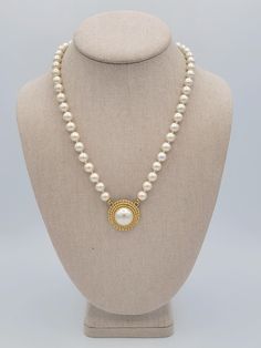 Vintage White Single Strand Faux Pearls with Round Gold Tone Pendant Necklace This vintage necklace makes a great statement piece.  A single strand of white faux pearl beads is accented with a beautiful gold-tone & faux pearl round pendant.  The 19 1/2" long necklace secures with a spring-ring clasp.  This piece is in excellent, nearly new condition.   Dimensions: 19 1/2" length  Clasp: Spring Ring Markings: None Condition: Excellent - nearly new All of my shop items are pre-owned vintage.  All Luxury Vintage White Beaded Necklace, Costume Jewelry Pearl Necklace With Pearl Pendant, White Pearl Chain Necklace Costume Jewelry, White Pearl Necklace Costume Jewelry, Pearl White Pearl Costume Jewelry Necklace, Pearl White Costume Jewelry Pearl Necklace, Single Strand Pearl Necklace Costume Jewelry, Single Strand Pearl Costume Jewelry Necklace, Single Strand Pearl Necklace For Costume Jewelry