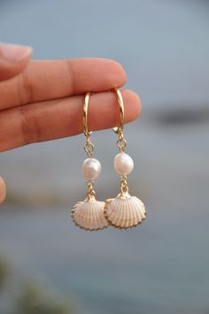 "Gold Dangle shell and pearl hoop earrings, 18k gold filled hoop earings, summer earrings, minimalist hoops, shell earrings, custom earrings The SHEILA earings are perfect for this spring summer. The hoops are in gold filled with fresh water pearl and a real shell with gold filled contour. My jewelry are hand made and done with high quality material. They are hypoallergenic and nickel free. DETAILS: ♥ Lenght 6cm (2.36\") , width  1.6cm (0.62\") ♥ Materials: gold filled 18k, fresh water pearl, shell ♥ style : minimalist If you need any futher information or customisation, feel free to contact me.  THANK YOU" Cheap Beach Season Earrings, Cheap Summer Beach Earrings, White 14k Gold Filled Hoop Earrings, Beachy Jewelry, Preppy Jewelry, Seashell Jewelry, Summer Earrings, Jewelry Accessories Ideas, Summer Earring