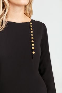 With Brooch Gold Buttons this top is perfect for your everyday look, keeping your style of-the-moment. Chiffon Outer Fully lined Brooch Gold Buttons with Crystal Embellishments Chic Embellished Blouse For Workwear, Elegant Spring Blouse With Button Back, Elegant Blouse With Button Back For Work, Chic Embellished Formal Blouse, Elegant Embellished Tops For Workwear, Elegant Gold Top With Button Closure, Gold Party Tops With Buttons, Chiffon Outer, Black Tunic