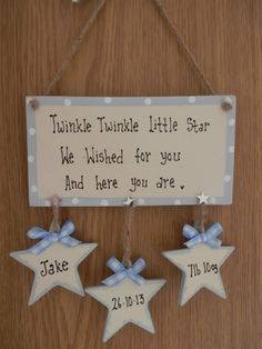 two little stars hanging on a wall with a sign that says twinkle twinkle little star we wishes for you and here you are