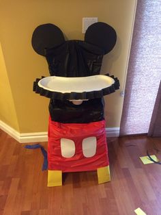 a mickey mouse costume made to look like it has been placed on top of a chair