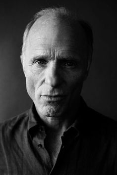 black and white photo of an older man looking at the camera with serious expression on his face