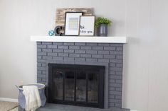 a living room with a fireplace and pictures on the mantle