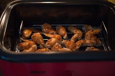 chicken wings cooking in an electric oven