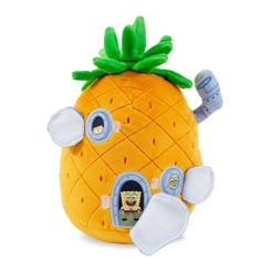 a stuffed pineapple has its eyes open to see what's inside the house