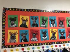 a bulletin board with pictures of children's hands and hand prints on the wall