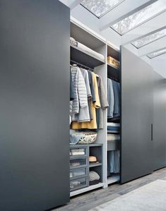 an open closet is shown with clothes and other items in it's storage area