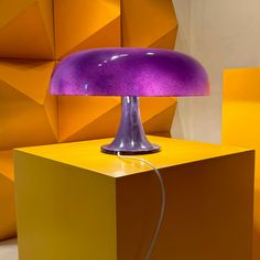 a purple lamp sitting on top of a yellow table