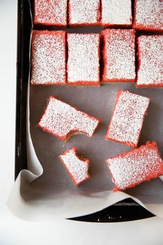 several square pieces of cake sitting on top of a pan