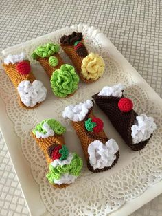 small crocheted food items are arranged on a tray