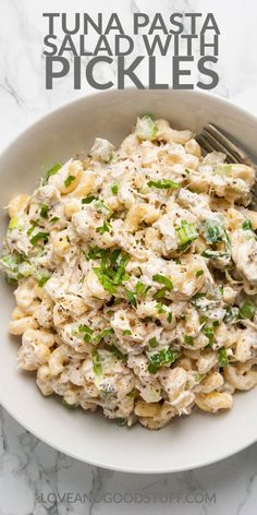 tuna pasta with pickles in a white bowl on a marble counter top and the title overlay reads tuna pasta pickles