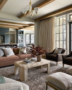 a living room filled with furniture and lots of windows